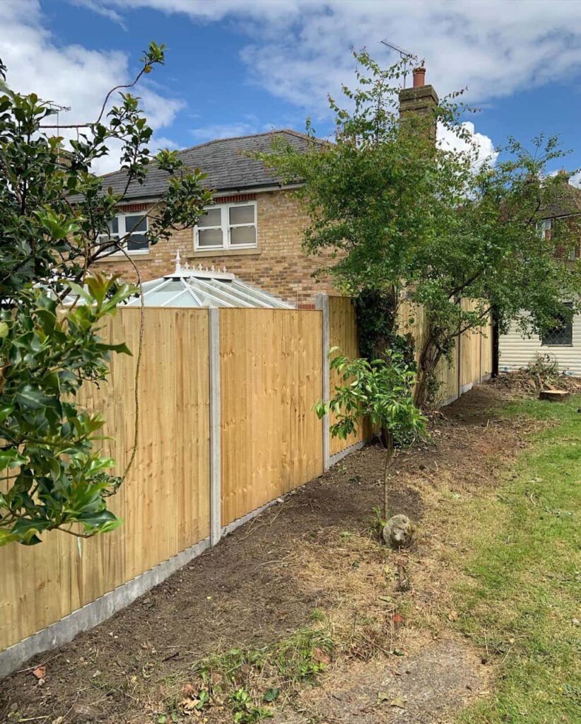 This is a photo of fence panels installed in a residential garden using concrete posts and gravel boards. Installed by Fast Fix Fencing Milton